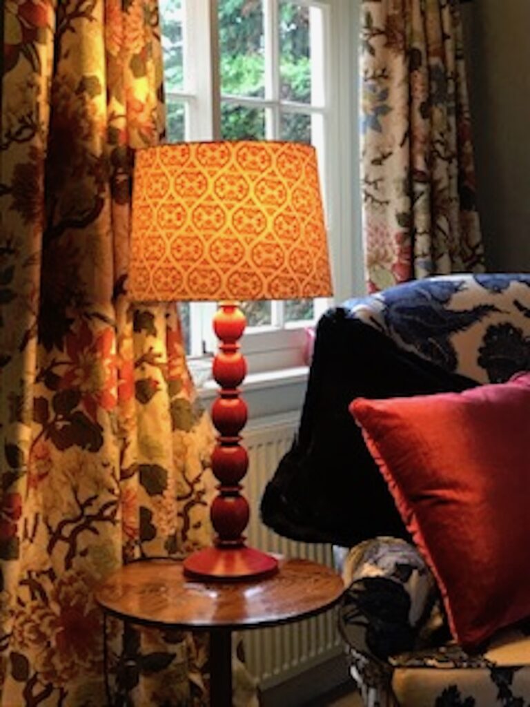 orange lamp wooden base patterned curtains